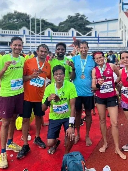 The team with their finisher medals at the Bengaluru Marathon. Everyone looks tired but happy after a strong performance.