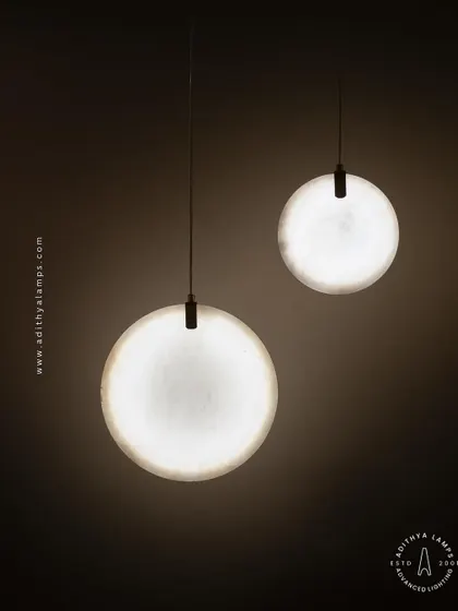 Showcasing our disc-shaped marble pendants. The light emanates softly through the thin slice of natural marble, revealing its unique veining. These fixtures are available in different shapes and look stunning hung in pairs or trios.