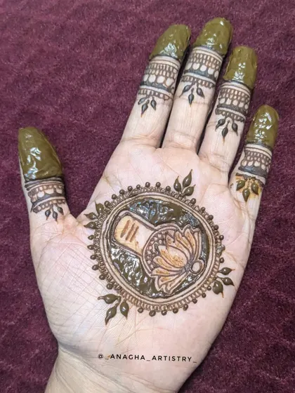 The fresh henna paste on the Mahadev mandala design. You can see the clean lines and the details within the central circle.