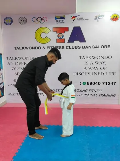 Tying a yellow belt.