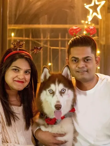 The perfect holiday family portrait with Walt the Husky and his parents. Everyone is wearing their reindeer antlers and ready to celebrate the season together.