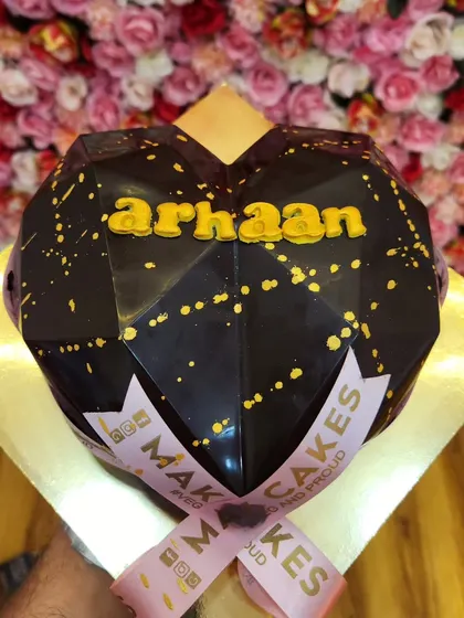 A geometric heart-shaped piñata cake. This hollow chocolate shell can be filled with candies or other treats and is meant to be smashed open for a fun surprise.