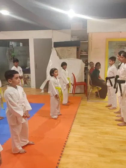 Discipline and respect are fundamental to our training. Students line up before their instructors during a belt examination, a formal process that tests their skills and understanding of karate principles.
