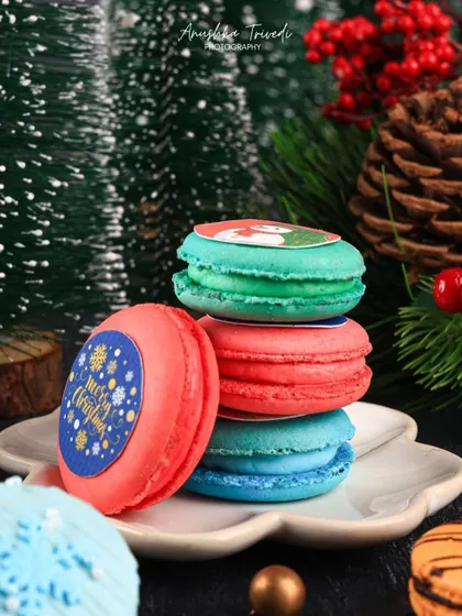 Another angle of the festive macarons, highlighting the custom "Merry Christmas" prints on them.