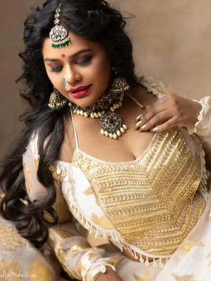 This is a more artistic and modern look, featuring a unique oxidized silver-tone choker with matching jhumkas and maang tikka. It is perfect for someone who wants to make a bold statement.