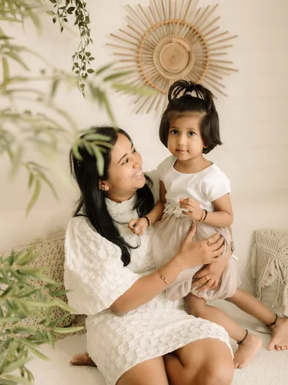 A beautiful mother-daughter portrait, showcasing the bond between them in the soft light of the studio.