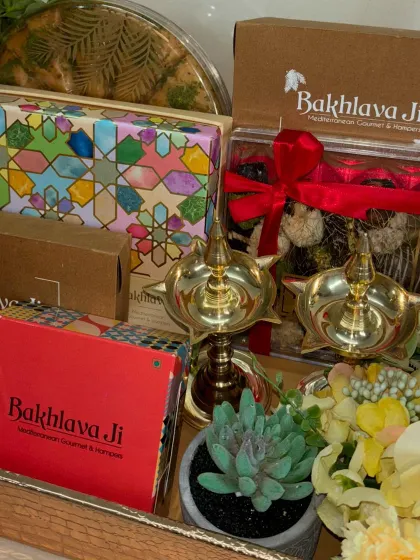 A delicious collaboration with Bakhlava Ji. We incorporated their Mediterranean gourmet sweets into this festive hamper, pairing them with traditional brass diyas and a succulent plant.