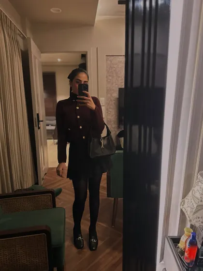 A chic winter look with a cropped cardigan, skirt, and platform loafers.