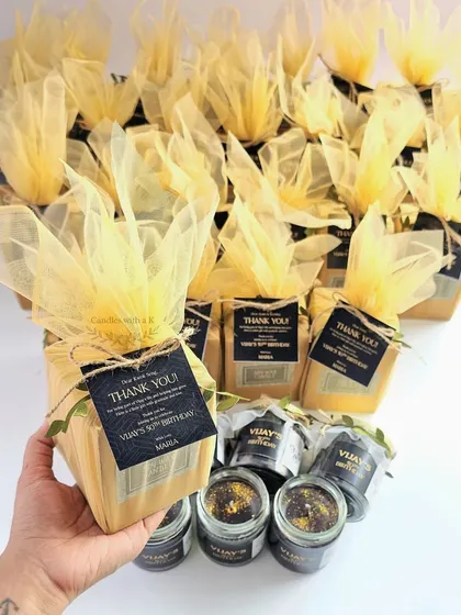 Holding one of the elegant black and gold gift boxes for the 50th birthday celebration.