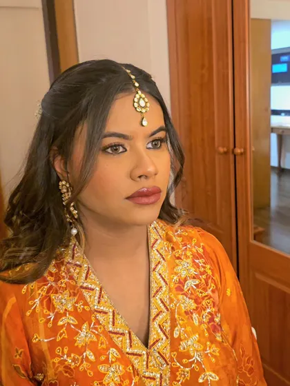 A close-up of Monica's makeup, featuring a bold lip and defined eyes.