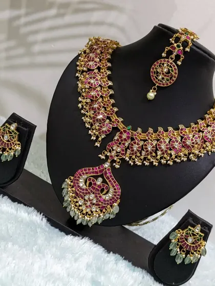 The pink Jadau set displayed, ready to bring a pop of color to your event.