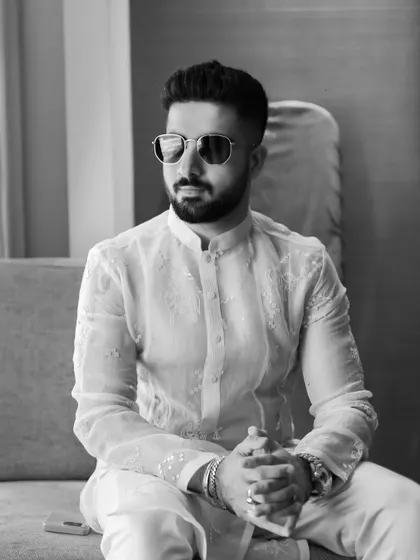 A stylish black and white portrait of the groom, looking relaxed and happy before the Haldi festivities begin. We make sure to capture solo portraits that reflect the groom's personality.