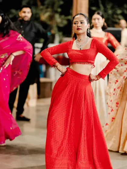 The bride showing off her dance moves. The hairstyle and makeup are designed to be secure and long-lasting, perfect for a performance.