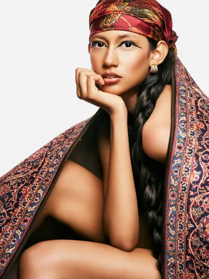 Exploring the intersection of heritage and high fashion. The look combines a traditional head covering and a long, classic braid with a sharp, modern eyeliner to create something new.