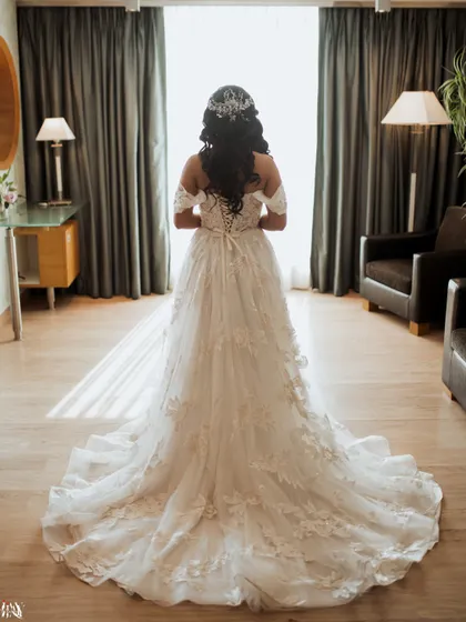 A portrait from behind, showcasing the beautiful train and intricate details of the bride's wedding gown.