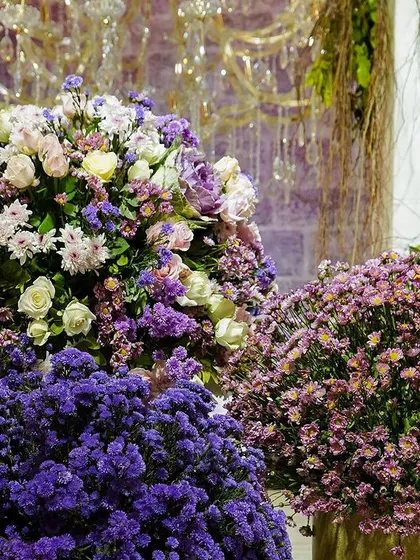 A close-up of the lush floral arrangements, showing the beautiful mix of textures and shades of purple and pink.