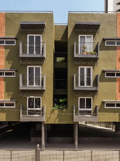 The facade of the Pixel 2 apartment building is a nod to Bengaluru's identity. We used locally sourced red bricks reminiscent of colonial architecture and a textured green plaster inspired by the "Garden City" tag. Each unit features a balcony with grills inspired by old bungalow gates, blending nostalgia with modern design.
