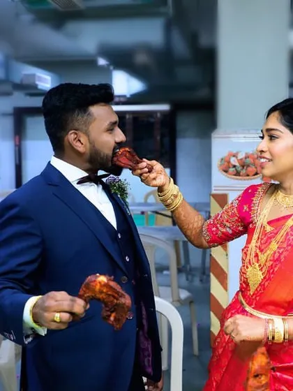 The bride playfully feeds the groom a piece of our delicious roasted chicken. These are the happy memories we help create at every wedding we cater.