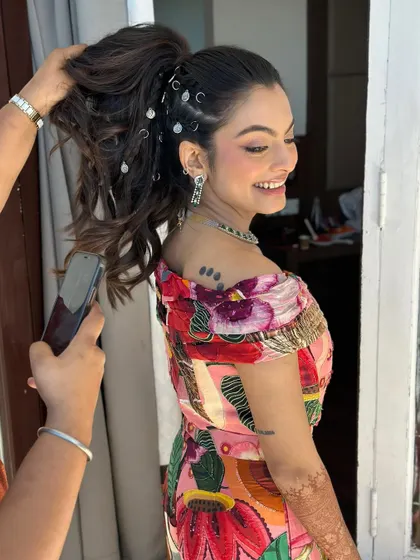 A fun, behind-the-scenes shot of the carnival look. The playful hairstyle with rings and the reverse wing makeup are full of character and carefree spirit.