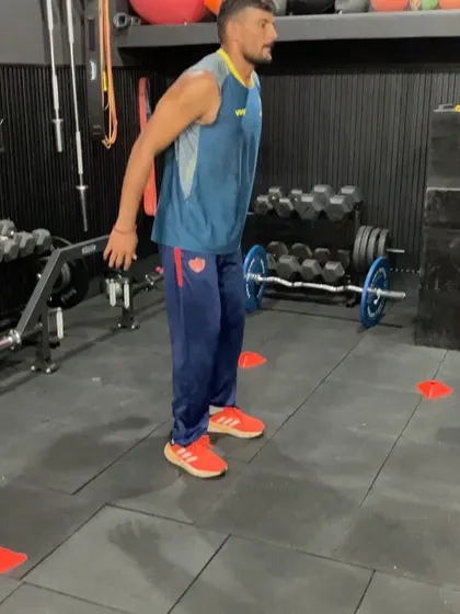 An athlete performing a depth jump. This advanced plyometric drill improves reactive strength by minimizing ground contact time and maximizing vertical jump height, a key indicator of explosive power.