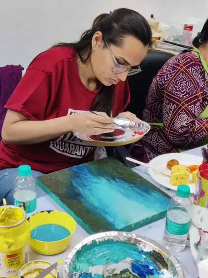 More scenes from our acrylic workshop for doctors, showing the focus and enjoyment as they mix colors and bring their canvases to life.