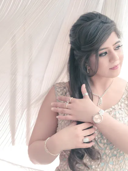 An elegant and soft portrait of a bride-to-be at her engagement. The light filtering through the curtains creates a dreamy, ethereal glow.