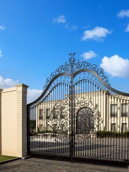 The entrance to The Grand Alabaster is marked by magnificent, custom-designed iron gates. This grand entryway sets a tone of exclusivity and timeless charm, hinting at the architectural splendor that lies within the estate.