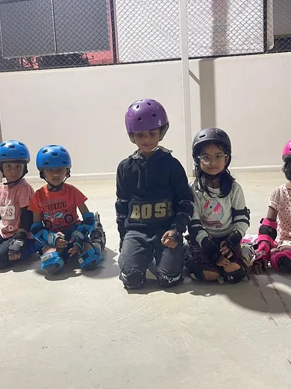The same group of skaters, sitting down but still full of energy. Our classes are as much about making friends and having fun as they are about learning to skate.
