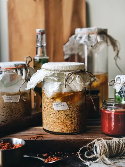The final shot from my sourdough series, featuring homemade fermented sauces and pastes in rustic jars, telling a story of loving craft.