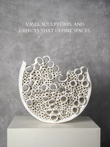 Vases, sculptures, and objects that define spaces. This intricate white ceramic sculpture, with its fascinating composition of hollow circles, is a testament to masterful craftsmanship. It is a piece that invites closer inspection, creating a focal point of texture and light.