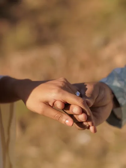 A close-up detail shot of their hands intertwined. This simple image is so powerful, symbolizing their connection and the commitment they are about to make.