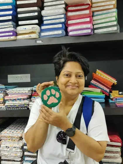 A perfectly executed paw print coaster, showcasing the fluffy texture of punch needle art.