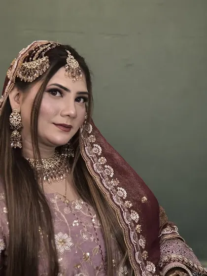 A portrait of the bride, showcasing her soft makeup and beautifully styled hair. The entire look is cohesive and elegant.