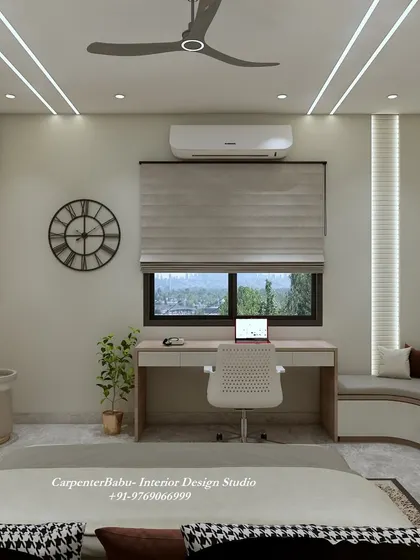 A guest bedroom with a light, feminine touch. The design includes a comfortable seating area, a functional desk, and a beautiful upholstered headboard.