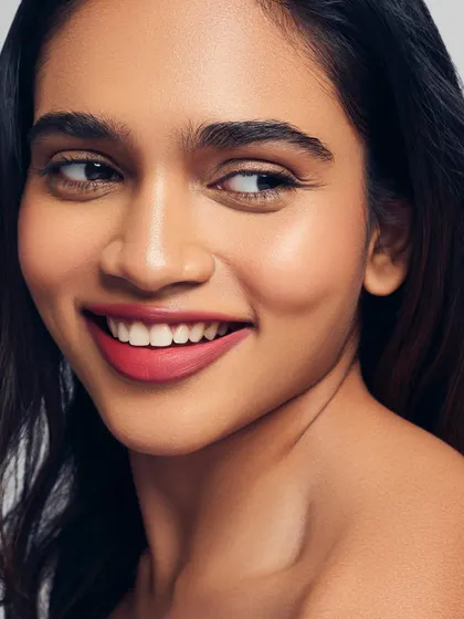 Radiant skin paired with a beautiful pink-red lip. This look is fresh, happy, and healthy, proving that great makeup starts with a great base.