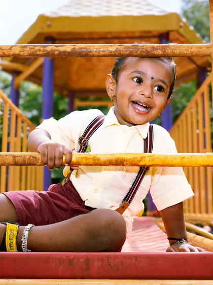 The pure, unfiltered joy of childhood is what I aim for in my kids' photography sessions. This little guy's laughter at the park made for a perfect, energetic shot that the family will cherish forever.