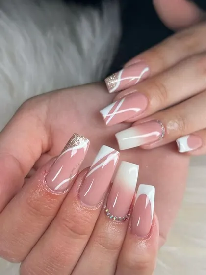 This set has it all. We combined a soft baby boomer ombré with a sharp French tip, abstract white lines, and a touch of gold glitter for a truly unique and glamorous design.