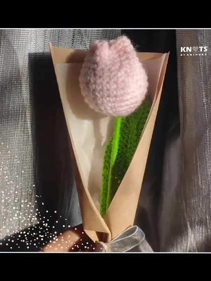 A single, delicate pink crochet tulip. It’s simple, elegant, and makes a lovely gift.