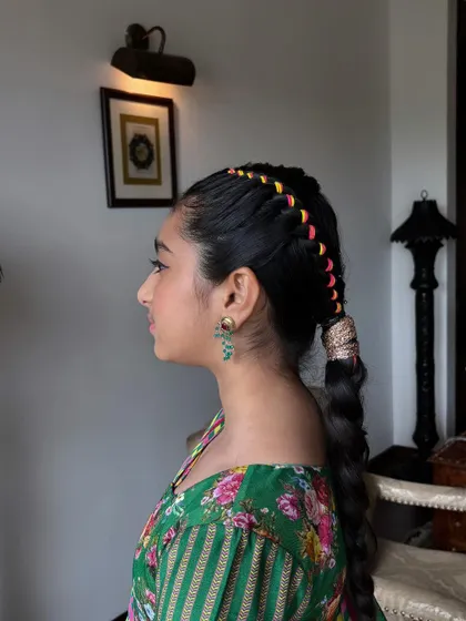 A side profile showcasing the thread-woven crown braid. This style is a fantastic way to add a pop of color and personality to a traditional hairstyle.