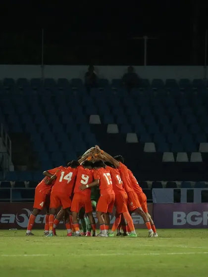 A team huddle before a big game. This image captures the unity and shared focus of the Indian U17 squad, a crucial element of team performance that we help cultivate.