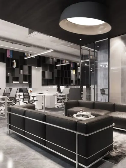 The design for the AU Real Estate office uses a transparent aesthetic with glass walls and an open layout. This approach fosters a progressive work culture and creates a visually connected, modern workspace with defined zones for collaboration and individual tasks.