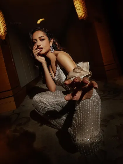 A glamorous sequined jumpsuit for Shanvi Srivastava. This look was for a high-fashion shoot, focusing on dramatic lighting and a powerful pose to highlight the outfit's texture and modern design.