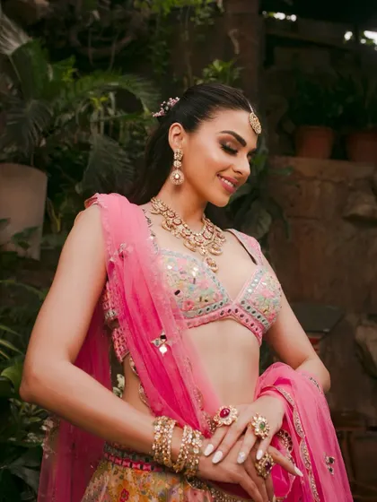 A candid and happy shot of the model, capturing the joyful essence of a Mehendi ceremony.