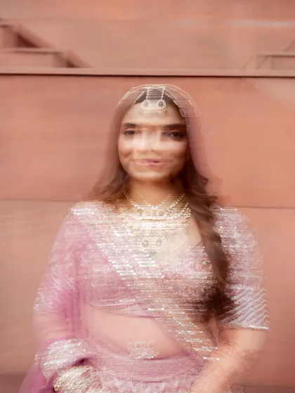 An artistic motion-blur shot of the bride, creating a dreamy and ethereal portrait. This creative technique captures the whirlwind of emotions and the magical atmosphere of the wedding day.