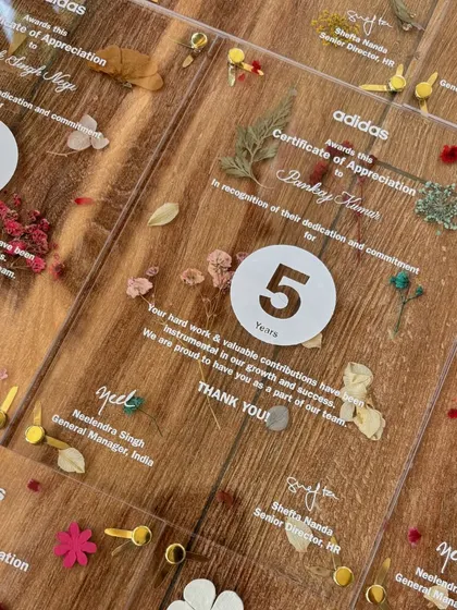 These acrylic certificates of appreciation for Adidas were a labor of love. Each piece features pressed flowers, screen-printed text, and custom calligraphy addressing to honor employees' years of dedication.