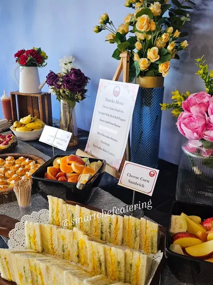 A glimpse of our elegant grazing table for a corporate office inauguration. The spread includes cheese corn sandwiches, fresh fruit, and crostini with red bell pepper sauce, all beautifully arranged.