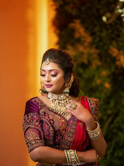 The full reception look, showing how to balance a rich velvet lehenga with vibrant, glowing makeup.