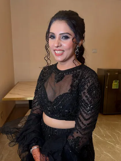 Glamorous smoky eyes and a glossy nude lip add drama to this all-black ensemble, creating a look that is pure elegance with an edge.