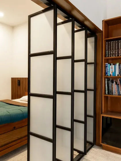 This before-and-after sequence shows how we reimagined a large, cluttered bedroom. By introducing a sliding partition and custom joinery, we created a multi-functional master suite with a cozy sleeping area, a wardrobe, and a bright study space, optimizing every inch of the room.