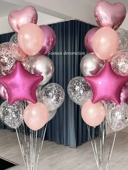 Two matching balloon bouquets perfect for placing on either side of an entrance or cake table. Each bunch includes pink, silver, and confetti-filled balloons.